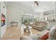 Bright living room with a glass table and view of the backyard pool at 19 Tomoka Cove Way, Ormond Beach, FL 32174