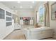 Bright living room featuring custom built-ins, hardwood floors, and large windows with natural light at 19 Tomoka Cove Way, Ormond Beach, FL 32174