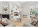 Comfortable living room featuring a fireplace, built-in shelving, and views of the outdoor patio at 19 Tomoka Cove Way, Ormond Beach, FL 32174