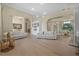 Expansive living room featuring hardwood floors, elegant arches, and two comfortable, modern sofas at 19 Tomoka Cove Way, Ormond Beach, FL 32174