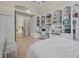 Main bedroom boasts built-in shelving, hardwood floors, and an adjacent entryway offering seamless movement through the home at 19 Tomoka Cove Way, Ormond Beach, FL 32174