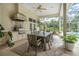Covered outdoor grill with bar and an outdoor dining area and pool views at 19 Tomoka Cove Way, Ormond Beach, FL 32174
