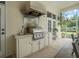 Covered outdoor grill and counter space perfect for entertaining and enjoying the outdoors at 19 Tomoka Cove Way, Ormond Beach, FL 32174