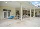 Covered patio space with seating, offering a relaxing area for outdoor living and entertaining at 19 Tomoka Cove Way, Ormond Beach, FL 32174