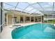 Screened-in pool area with a spa, covered patio, and ample seating at 19 Tomoka Cove Way, Ormond Beach, FL 32174