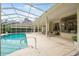 Inviting backyard pool area with covered patio and serene outdoor living space at 19 Tomoka Cove Way, Ormond Beach, FL 32174