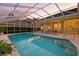 Inviting screened pool with spa and patio seating, perfect for relaxation and entertaining at 19 Tomoka Cove Way, Ormond Beach, FL 32174