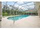 A beautiful in-ground screened pool features ample deck space and an attached hot tub at 19 Tomoka Cove Way, Ormond Beach, FL 32174