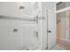 Beautiful tiled walk-in shower features glass surround and built-in shelving at 19 Tomoka Cove Way, Ormond Beach, FL 32174