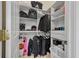 Walk-in closet with ample shelving and hanging space providing organization and storage for clothing and personal belongings at 19 Tomoka Cove Way, Ormond Beach, FL 32174
