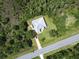 Aerial view of the home showcasing the property layout, surrounding trees, and road access at 19320 Oberly Pkwy, Orlando, FL 32833
