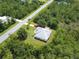 Aerial view of home and long driveway surrounded by mature trees and neighborhood streets at 19320 Oberly Pkwy, Orlando, FL 32833