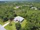 Aerial view showing house with a sprawling backyard surrounded by mature trees, and neighborhood at 19320 Oberly Pkwy, Orlando, FL 32833
