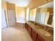 Bright bathroom featuring a soaking tub, double vanity, and ample natural light at 19320 Oberly Pkwy, Orlando, FL 32833