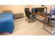 Bedroom with light colored wood flooring, a bed, and a desk at 19320 Oberly Pkwy, Orlando, FL 32833