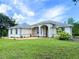 Charming single-story home with a beautifully landscaped front yard and inviting arched entryway at 19320 Oberly Pkwy, Orlando, FL 32833