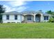 Inviting single-story home with a well-manicured lawn, decorative touches, and a welcoming double-door entrance at 19320 Oberly Pkwy, Orlando, FL 32833