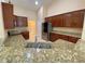 Modern kitchen features granite countertops, stainless steel appliances, and ample cabinet space at 19320 Oberly Pkwy, Orlando, FL 32833