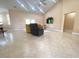 Spacious living room with high ceilings, tile flooring, comfortable seating, and a mounted TV at 19320 Oberly Pkwy, Orlando, FL 32833