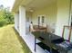 Covered patio with dining table, ceiling fan, and outdoor grill at 19320 Oberly Pkwy, Orlando, FL 32833