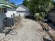 Gravel area for parking in backyard with AC unit, adjacent to a utility garage/shed structure at 1973 S Old Mill Dr, Deltona, FL 32725