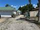 The backyard features a gravel area perfect for parking, with surrounding fences and trees at 1973 S Old Mill Dr, Deltona, FL 32725