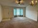Spacious living room with a large bay window and a ceiling fan, offering natural light at 1973 S Old Mill Dr, Deltona, FL 32725