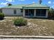 A cozy home featuring a screened-in porch for outdoor relaxation. with small yard area at 1973 S Old Mill Dr, Deltona, FL 32725