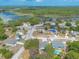 Aerial view of a neighborhood with many homes, lush greenery, and a lake in the distance at 198 Heather Lane Dr, Deltona, FL 32738