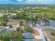 Gorgeous aerial view of homes nestled within lush greenery, trees, and tranquil ponds under a picturesque sky at 198 Heather Lane Dr, Deltona, FL 32738