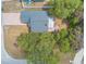 Top-down aerial shot showcases home with brick driveway, complemented by lush greenery and tree coverage at 198 Heather Lane Dr, Deltona, FL 32738