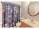 Bathroom featuring a sun and moon shower curtain, a round mirror, and vanity at 198 Heather Lane Dr, Deltona, FL 32738