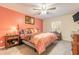 Comfortable bedroom featuring a ceiling fan, nightstand, and accent wall at 198 Heather Lane Dr, Deltona, FL 32738