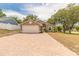 Charming single-story home with a brick driveway and well-maintained lawn and mature trees at 198 Heather Lane Dr, Deltona, FL 32738