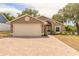 Charming single-story home with a brick driveway and well-maintained lawn and mature trees at 198 Heather Lane Dr, Deltona, FL 32738