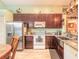 Open kitchen with stainless steel fridge and farmhouse sink offering ample counter space at 198 Heather Lane Dr, Deltona, FL 32738