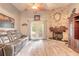 Inviting living room with stone fireplace, hardwood floors, and comfortable leather seating at 198 Heather Lane Dr, Deltona, FL 32738