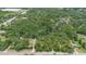 Aerial view showcasing lush trees, roads and neighborhood nearby the property at 2 E Kelly Park Rd, Apopka, FL 32712