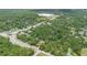 Aerial view of a community, showcasing lush greenery, roads, and buildings at 2 E Kelly Park Rd, Apopka, FL 32712