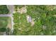 Aerial view of a home surrounded by trees, with a road nearby at 2 E Kelly Park Rd, Apopka, FL 32712