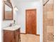 Well-maintained bathroom with a classic vanity, neutral tile, and a shower, offering a clean and functional design at 2 E Kelly Park Rd, Apopka, FL 32712