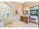 Well-lit bathroom with a tiled shower, vanity, and marble countertop, providing a luxurious and functional space at 2 E Kelly Park Rd, Apopka, FL 32712