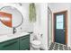 Bathroom featuring vanity with green cabinets, vessel sink, and shower with black and white tiles at 2 E Kelly Park Rd, Apopka, FL 32712