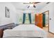 Bright bedroom with a ceiling fan, large window and a comfortable bed, creating a cozy and inviting atmosphere at 2 E Kelly Park Rd, Apopka, FL 32712