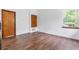 Empty room featuring wood floors, natural light and white walls providing a blank space to make your own at 2 E Kelly Park Rd, Apopka, FL 32712