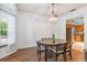 Charming dining room adjacent to kitchen with natural light and modern chandelier at 2 E Kelly Park Rd, Apopka, FL 32712