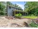Spacious backyard with a charming patio area, stone accents, and lush landscaping at 2 E Kelly Park Rd, Apopka, FL 32712