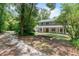 Charming two-story home with a welcoming front porch, lush landscaping, and a serene country setting at 2 E Kelly Park Rd, Apopka, FL 32712