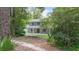 Two-story home with a inviting front porch, surrounded by trees and landscaped yard at 2 E Kelly Park Rd, Apopka, FL 32712