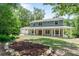Charming two-story home features a wide, welcoming front porch and a beautifully landscaped front yard at 2 E Kelly Park Rd, Apopka, FL 32712